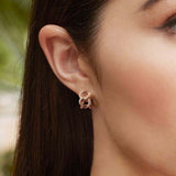 APM Monaco Chain Huggie Earrings in APM rose alloy