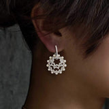 APM Monaco Asymmetric Sun Earrings with pearls in white silver